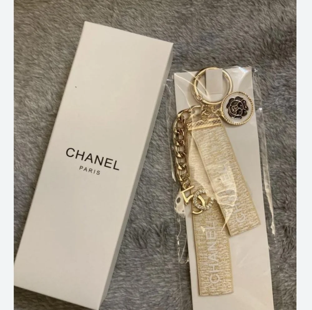 CHANEL Paris Gold-Tone Key Holder with Beige Ribbon and Camellia Charm